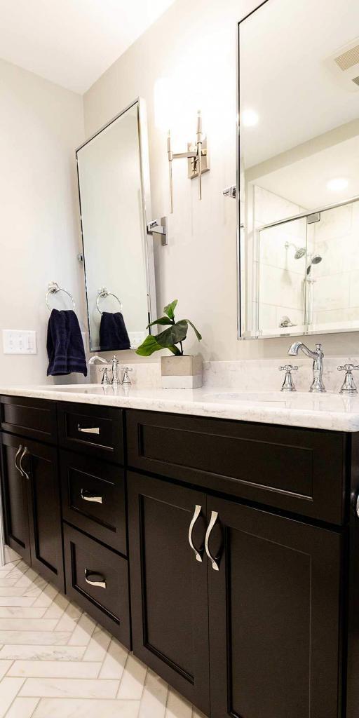 bathroom with black cabinets and white counters
