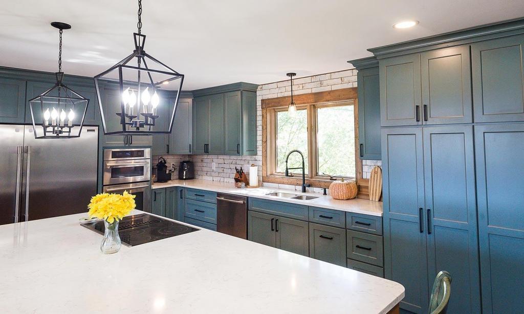 modern kitchen with teal cabinets and custom tile backsplash
