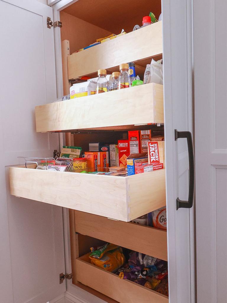 pull out drawers in a kitchen with white cabinets
