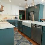 New kitchen with green cabinets and white counters
