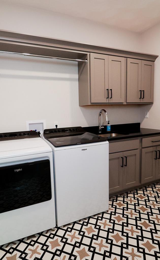 laundry room with dark gray cabinets