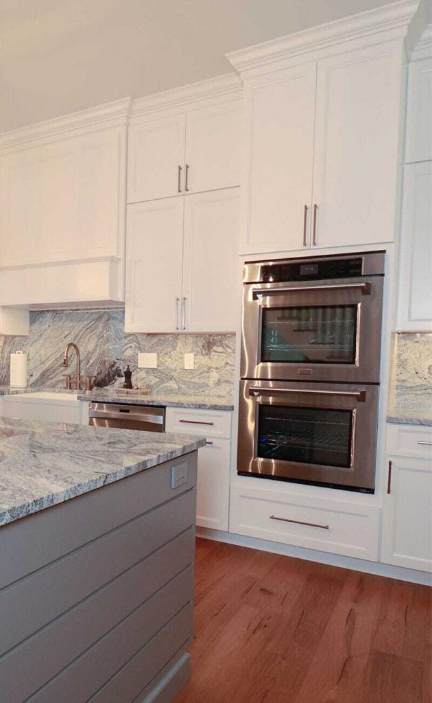 luxury kitchen with white cabinets and quartz counter
