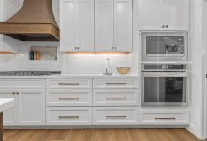 White kitchen with a wooden hood.
