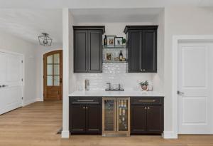Modern Farm house style featuring black cabinets and white subway tile for the backsplash.
