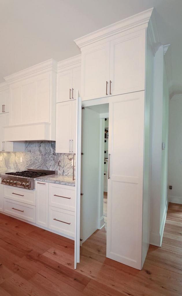 A dazzling kitchen with the secret pantry behind the cabinet door.