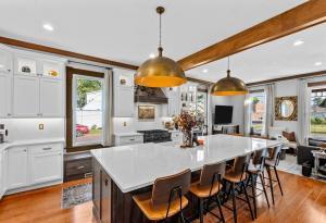 A beautiful kitchen remodel in the metro-St. Louis area featuring white quartz, copper detailed light fixtures.