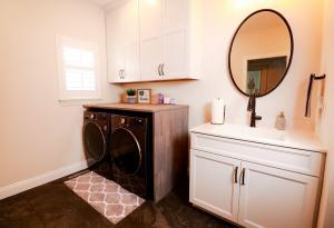 Rustic laundry room with natural wood counter tops and Ivory Koch Cabinets.