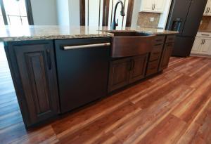 Modern farm house style kitchen with rustic red oak stained floor.