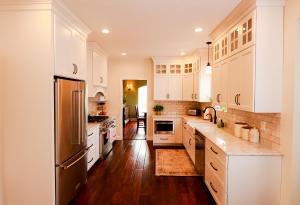 Rustic kitchen remodel with backlit upper cabinets, Ivory Koch Cabinets complete with subway tile backsplash.