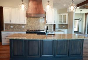 A new kitchen featuring Koch cabinets and a wooden exhaust hood.