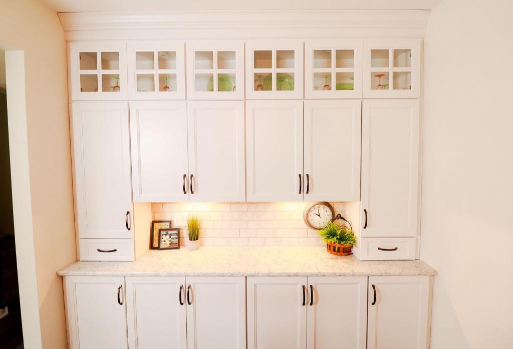 Rustic kitchen remodel with backlit upper cabinets, Ivory Koch Cabinets complete with subway tile backsplash.