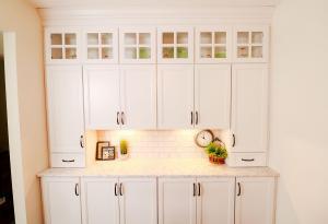 Rustic kitchen remodel with backlit upper cabinets, Ivory Koch Cabinets complete with subway tile backsplash.