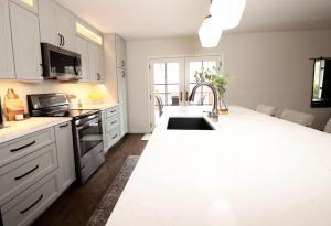 Beautiful kitchen in Waterloo, IL. Featuring dark wood cabinets and quartz counters.