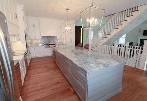 Columbia, IL, beautiful kitchen remodel. High quality quarts and white custom Koch Cabinets.