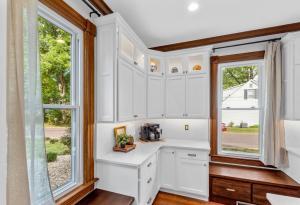 A beautiful kitchen remodel in the metro-St. Louis area that features bright whit Koch Cabinets with backlighting.
